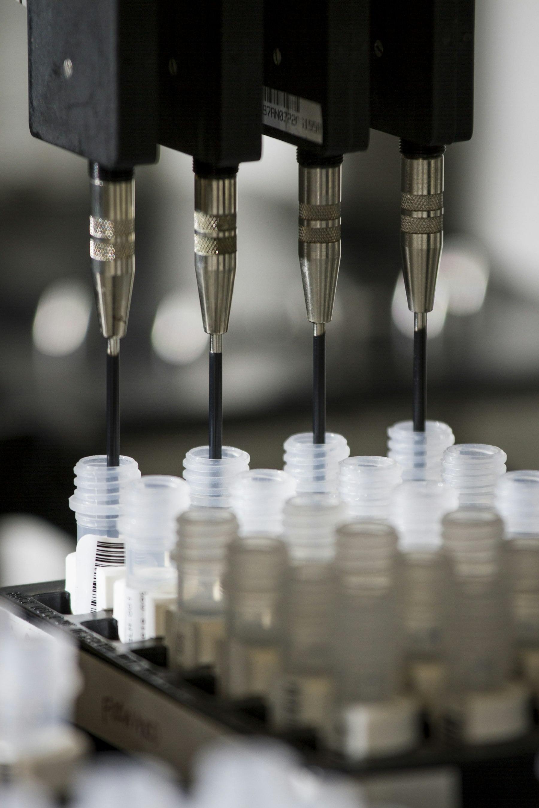 Autosampler needles drawing from a tray of barcoded sample vials